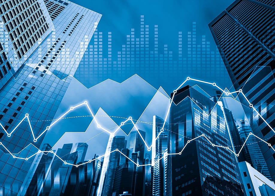 An illustration of skyscrapers with financial graphs and digital indicators overlay as a concept of finance and trading. — Summit Art Creations // Shutterstock