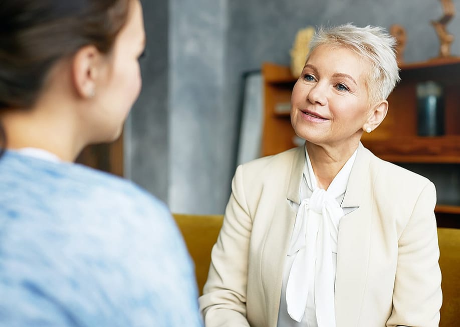 An HR advisor discussing their company's AI adoption and progress to a people manager in the office. — shurkin_son // Shutterstock