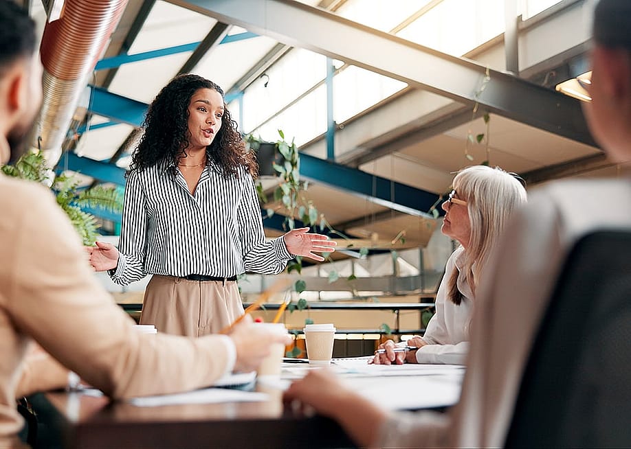 Business managers discussing ideas about rebranding after an acquisition in an office meeting. — PeopleImages // Shutterstock