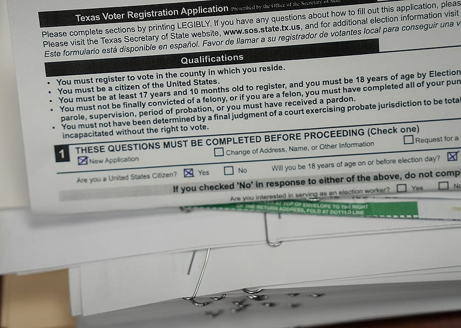 Voter registration forms stacked at the Loving County offices in Mentone, Texas, USA. — Elizabeth Conley // Houston Chronicle via Getty Images