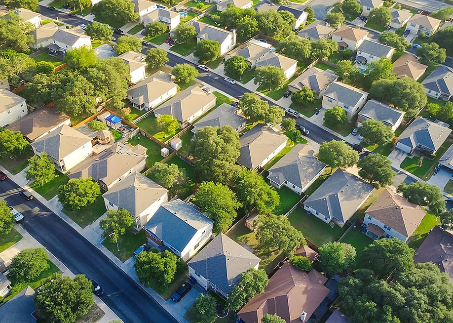 An aerial view of single suburban house driveways in San Antonio, Bexar County, Texas, USA. — Trong Nguyen // Shutterstock