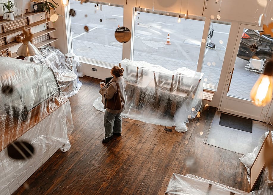A business owner planning an interior renovation of a modern cafe. — Dean Drobot // Shutterstock