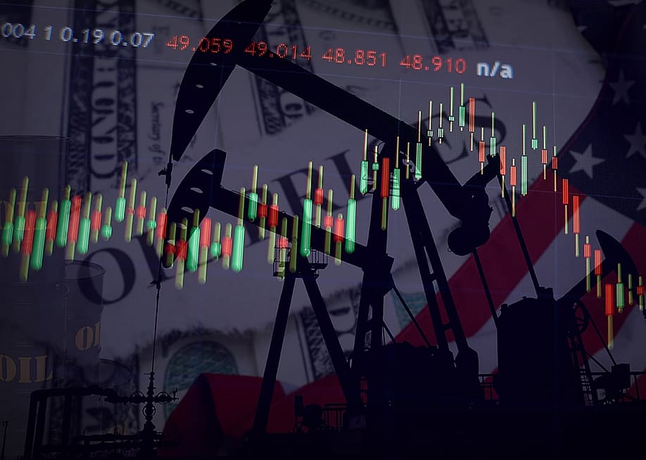 Oil pump jacks and market charts illustrate the United States energy economy with dollar bills and the American flag. — Sandinashr // Shutterstock