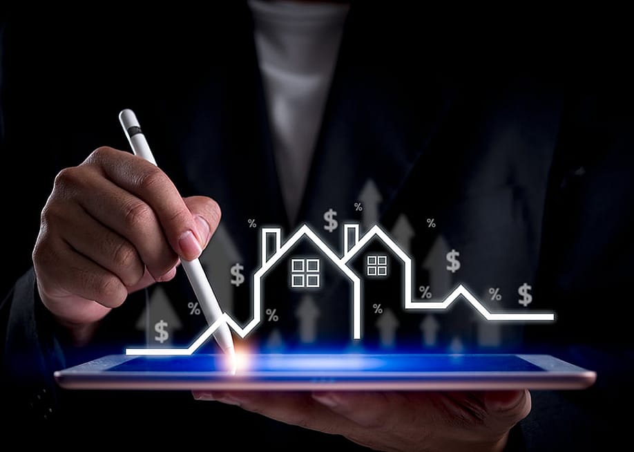 A financial specialist analyzing the real estate industry and its market growth on a digital tablet. — khunkornStudio // Shutterstock