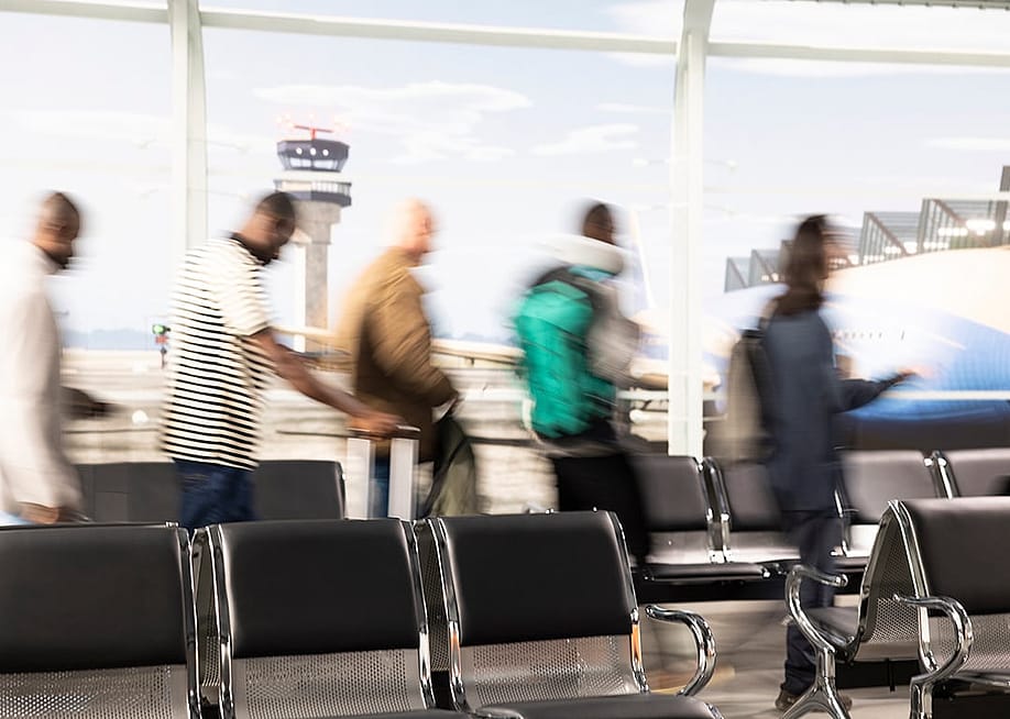 Passengers walking quickly at an airport terminal. — DC Studio // Shutterstock