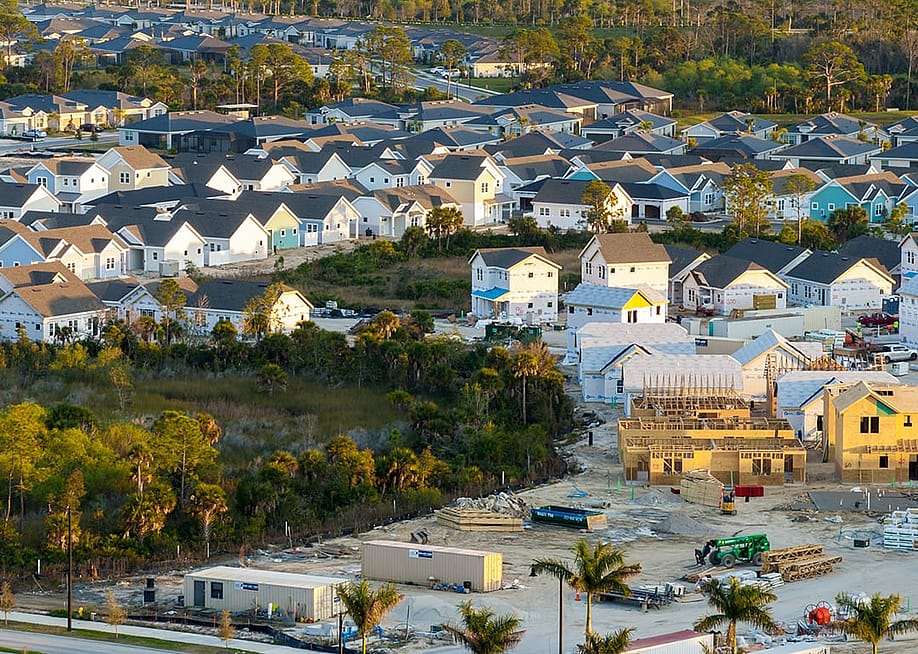 A construction of residential homes happening in a newly developed suburban area. — Bilanol // Shutterstock