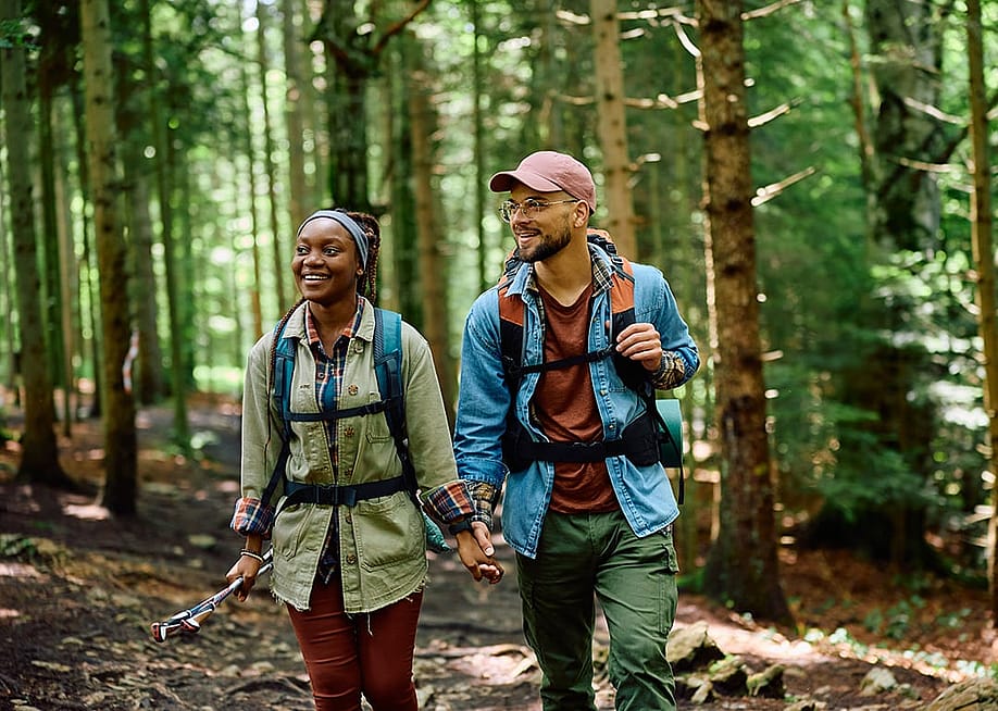 A couple hiking in a forest. — Drazen Zigic // Shutterstock