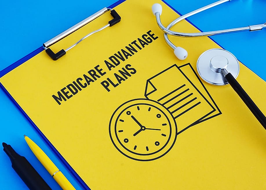 A clipboard holding a Medicare Advantage Plans file. — Jack_the_sparow // Shutterstock