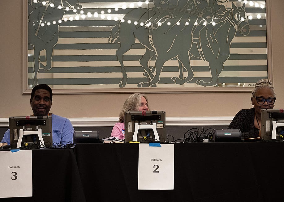 Poll workers wait for voters during early voting at Laurel Race Track October 28, 2022, in Laurel, Maryland. — BRENDAN SMIALOWSKI // AFP via Getty Images
