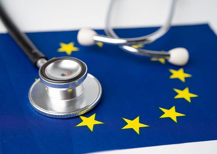 A stethoscope on top of an EU flag. — sasirin pamai // Shutterstock