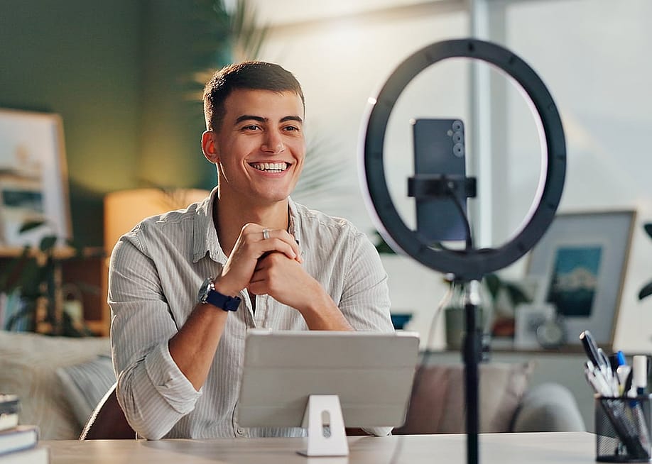 Man at home recording with smartphone for social media. — PeopleImages // Shutterstock