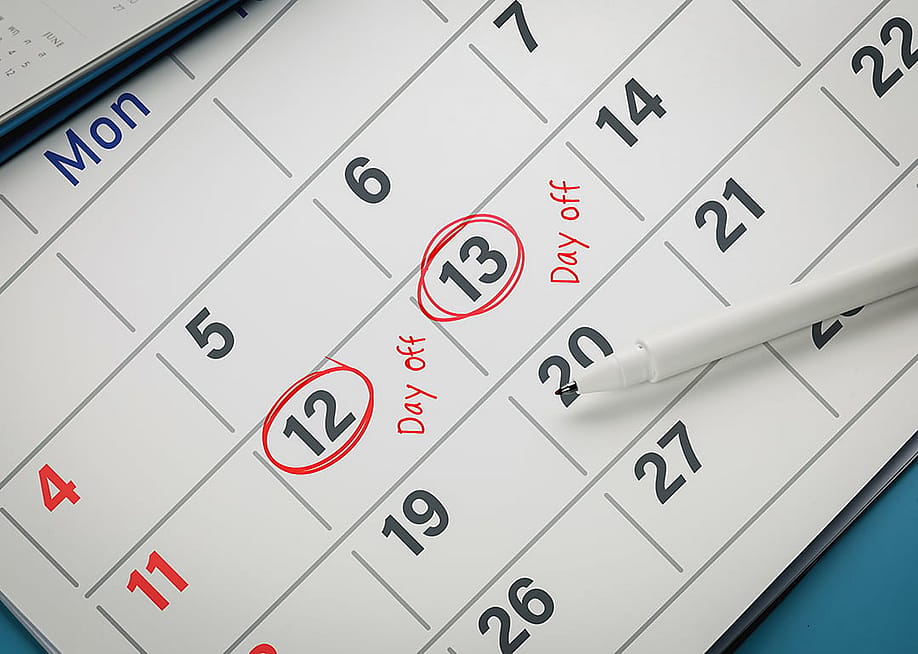 Dates marked in red for day off reminders on a calendar. — Midnight Studio TH // Shutterstock