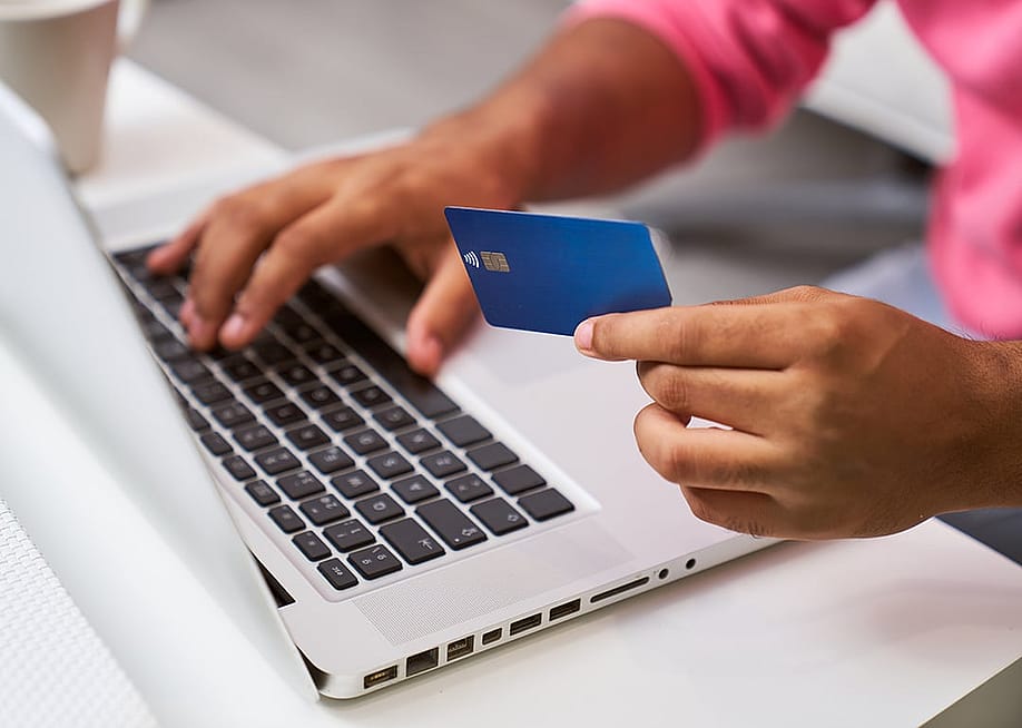 Person shopping online using a credit card. — Retamosa // Shutterstock