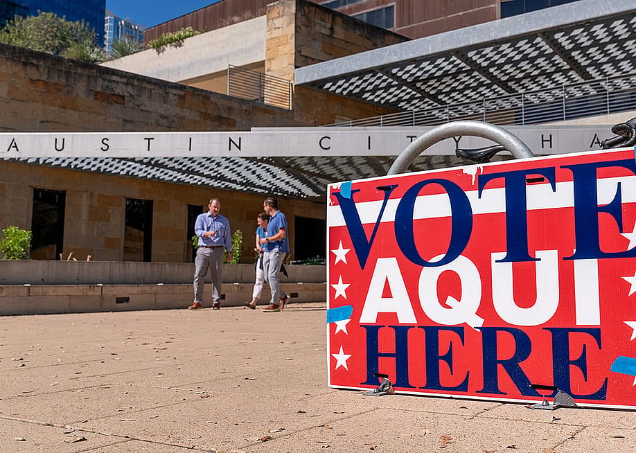 A voting sign in Spanish and English seen outside as voters leave Austin City Hall's polling place during the presidential primary in Austin, Texas, USA. — SUZANNE CORDEIRO // AFP via Getty Images