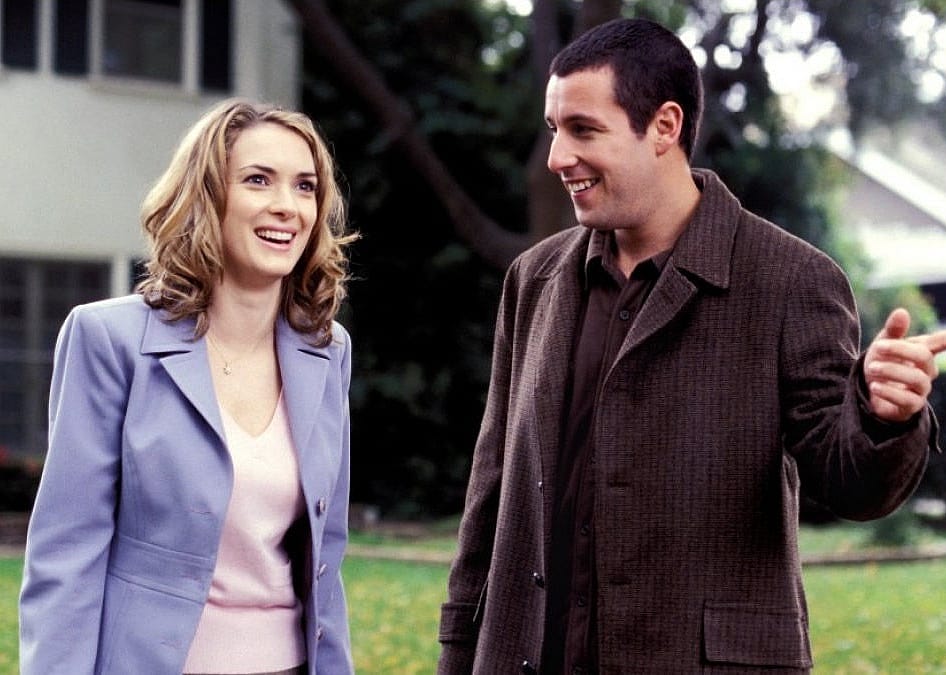 Winona Ryder and Adam Sandler laughing.