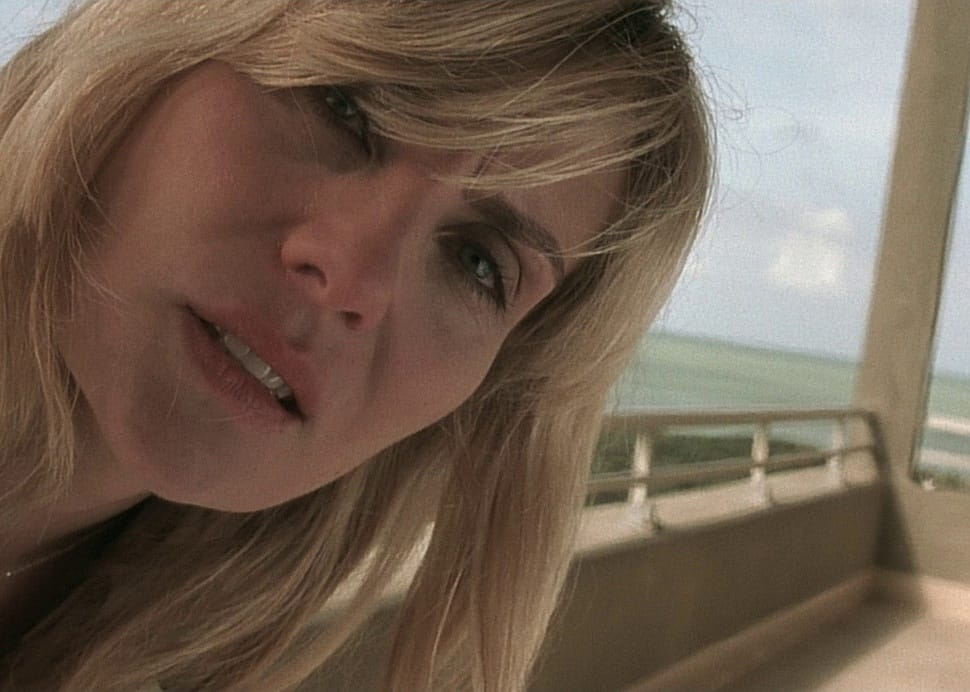A woman looks closely at something.