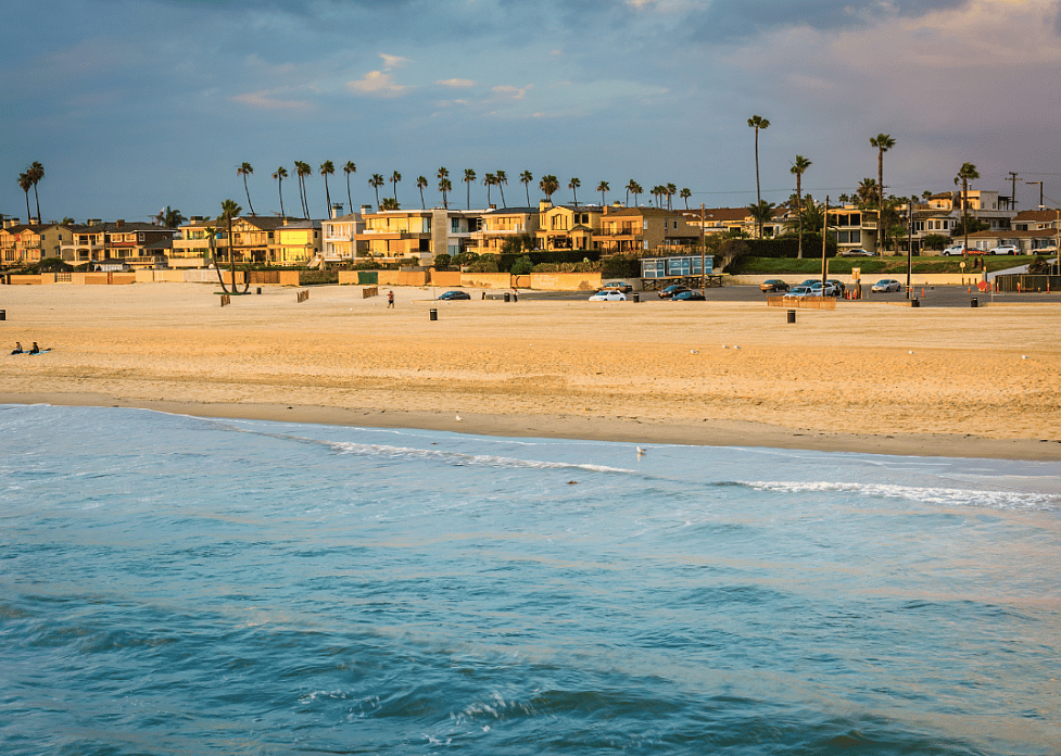 Waves in the Pacific Ocean and the beach at sunset in Seal Beach, California