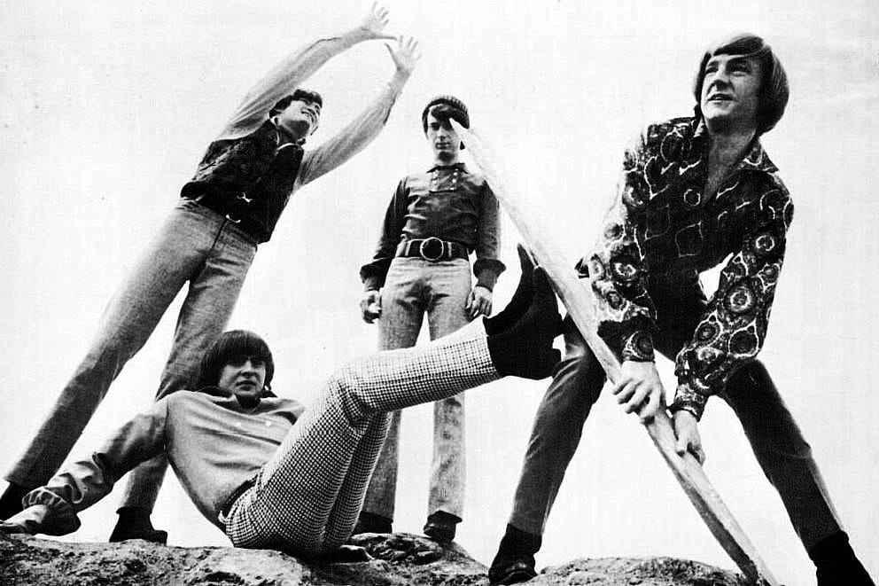 The Monkees frolic on the beach for a photo shoot